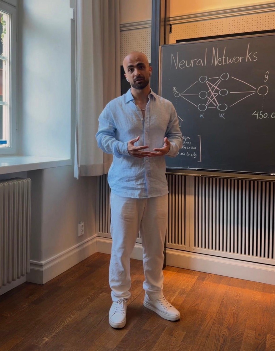 Majd Jamal explaining a neural network at a blackboard